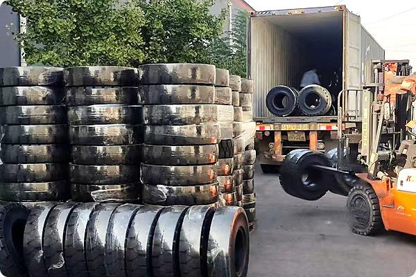 JABIL solid tyres being loaded into export container by forklift