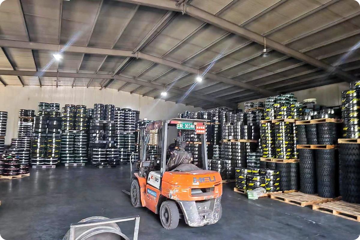 JABIL solid tyre warehouse – forklift operating among stacked tyre inventory on pallets