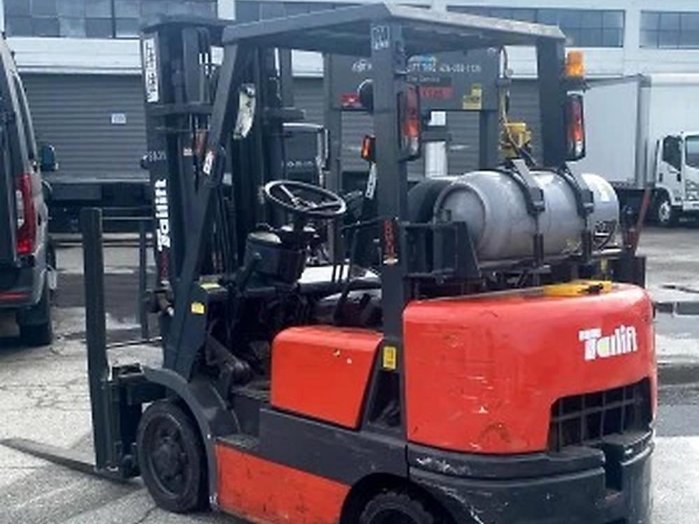 LPG counterbalance forklift with solid tyres at industrial manufacturing plant yard