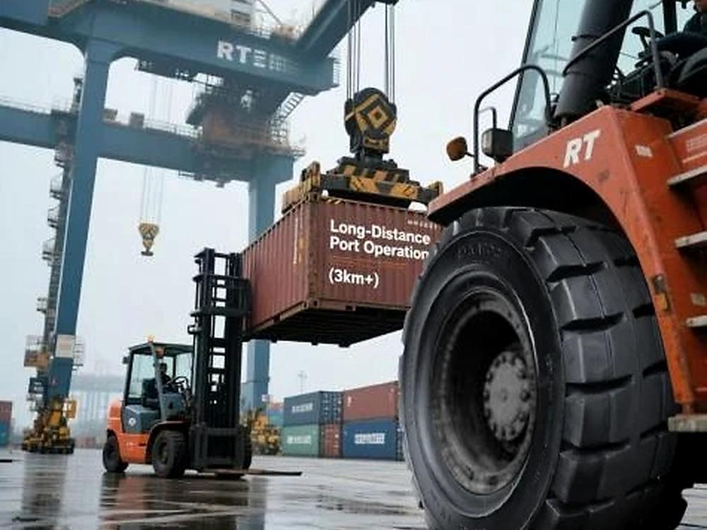 Heavy-duty reach stacker handling shipping container at port terminal